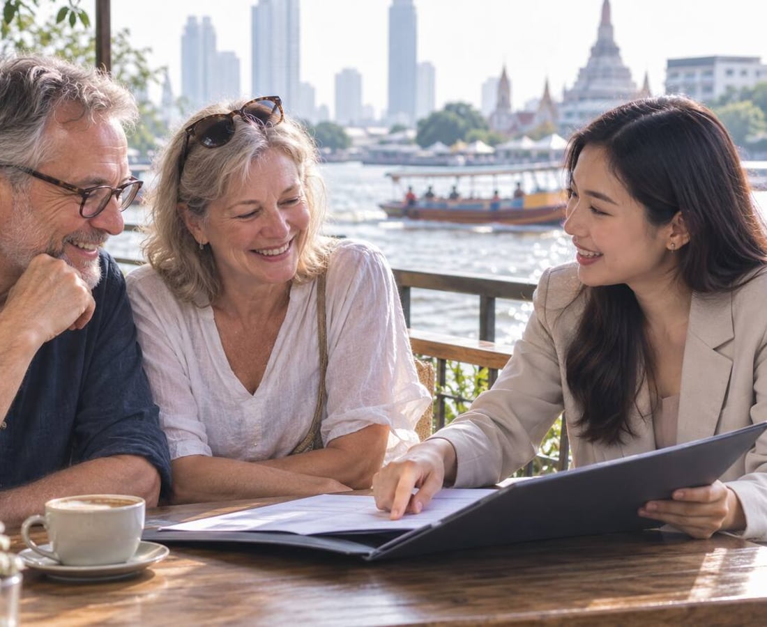 A retired couple going through visa papers with an adviser